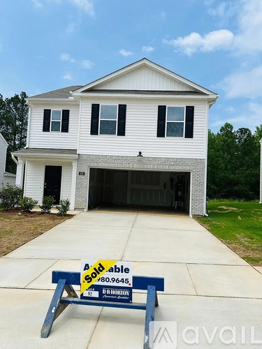 A house with a sold sign in front of it.