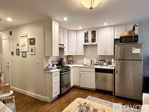 A kitchen with white cabinets and stainless steel appliances.