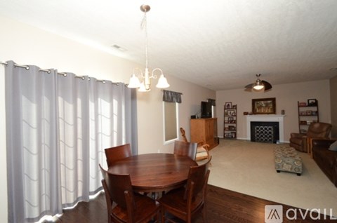 A living room with a dining table and chairs.
