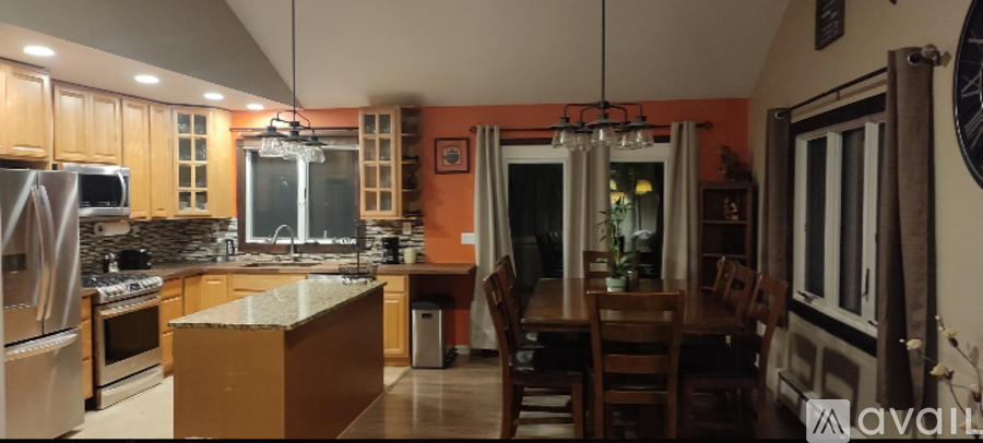 A kitchen with wooden cabinets and a granite countertop.