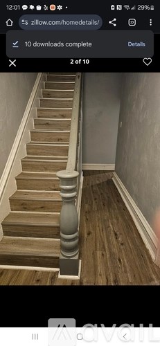 A staircase with wooden steps and a grey handrail.