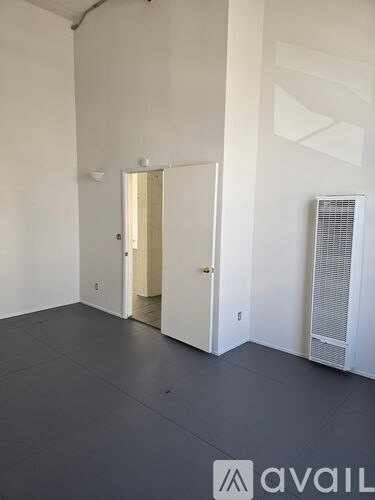 A room with a white door and a white wall.