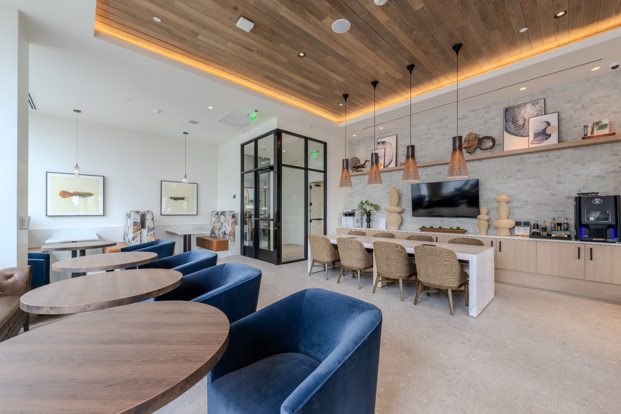 A modern living room with a blue sofa and a wooden table.