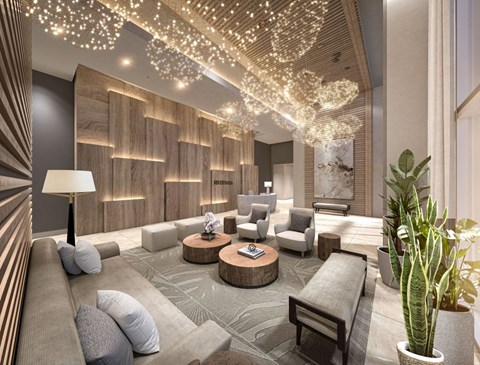 A modern living room with a grey sofa, wooden wall paneling, and a chandelier.