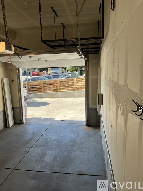 A view of a parking lot from a covered walkway.