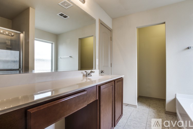 A bathroom with a large mirror and a sink.