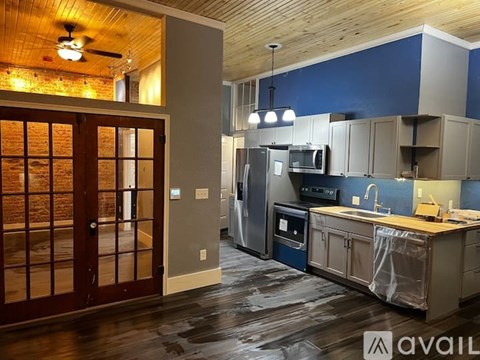 A kitchen with a refrigerator, oven, and sink is available for rent.