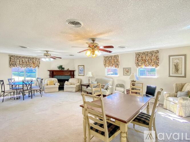 A living room with a dining table and chairs.