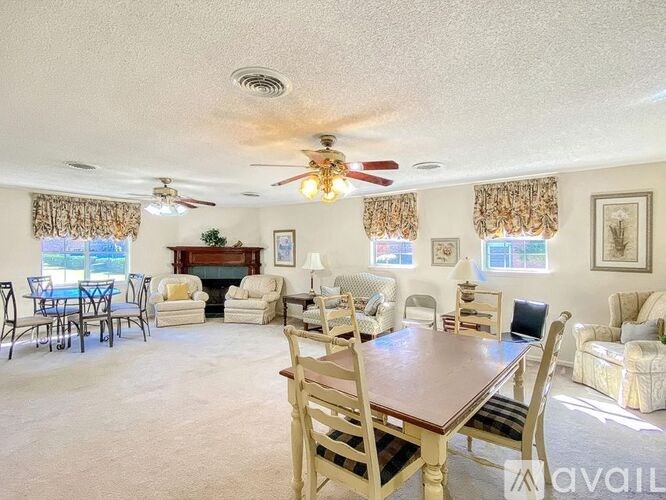 A living room with a dining table and chairs.
