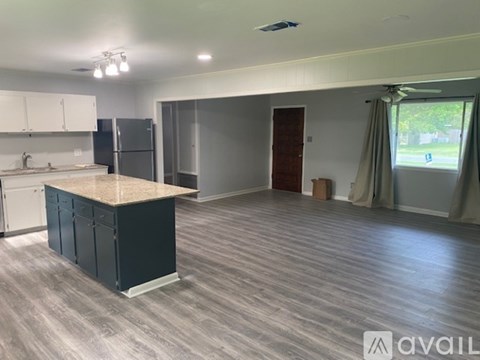 A kitchen with a sink, refrigerator, and cabinets is available for rent.