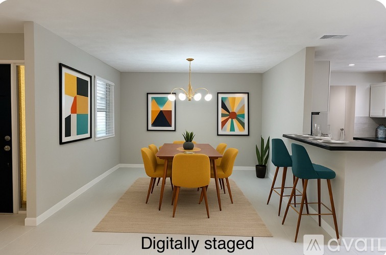 A dining room with a yellow table and chairs.