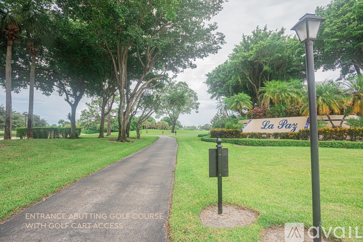 A pathway leading to the entrance of a golf course.