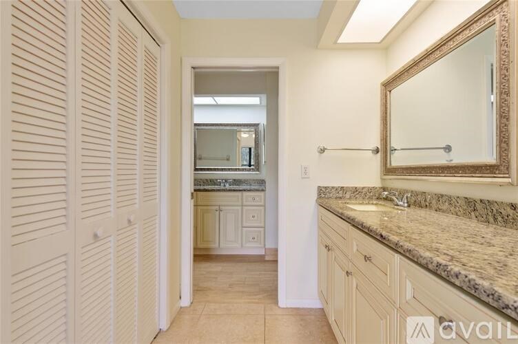 A bathroom with a vanity and a mirror.