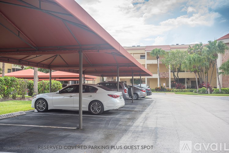 A covered parking area with a sign that says "Reserved Covered Parking Plus Guest Spot."