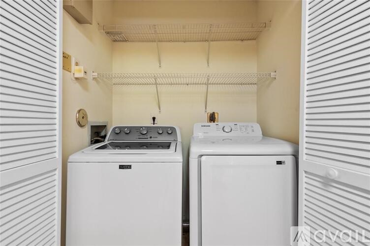 A white washing machine and dryer in a small laundry room.
