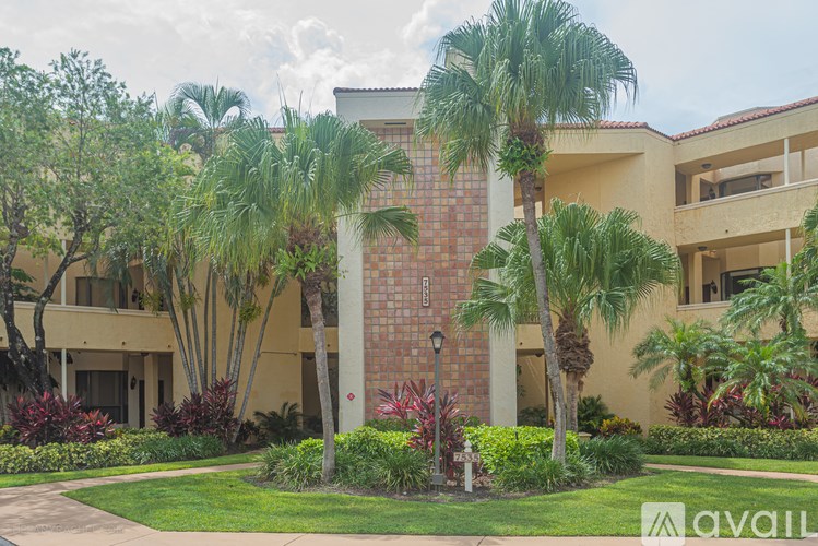 A building with a red brick pillar in front of it.