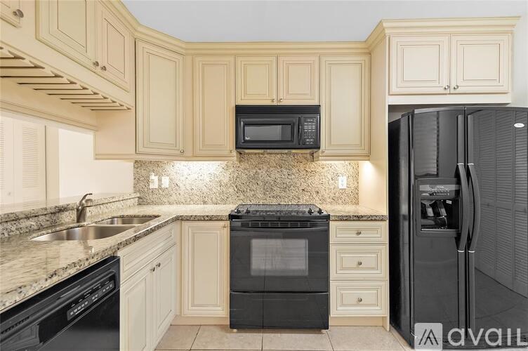 A kitchen with black appliances and a black refrigerator.