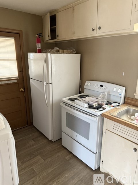 A white refrigerator and stove in a kitchen.