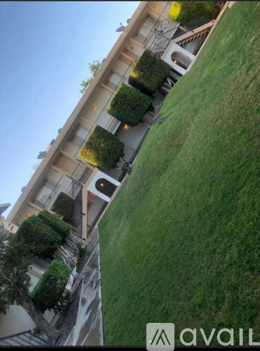 A building with a green lawn in front of it.