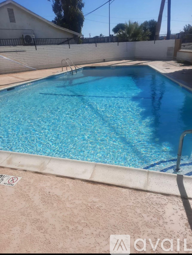 A pool with blue water and a no-entry sign on the floor.