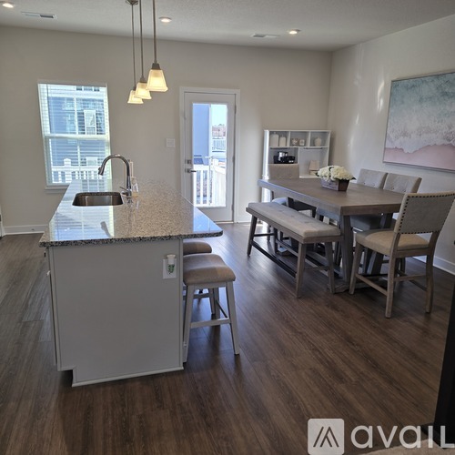 A kitchen with a counter and chairs.