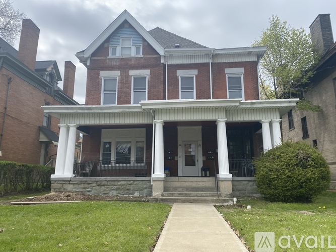 A house with a front porch and a covered walkway.