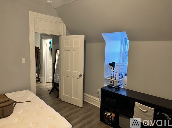 A bedroom with a bed, a dresser, and a mirror.