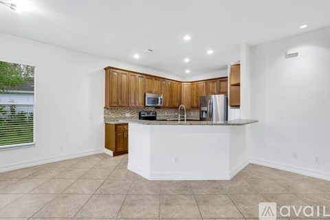 A kitchen with wooden cabinets and a white countertop.