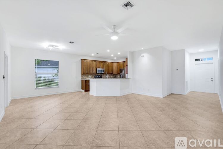 A spacious room with a ceiling fan and a reception desk.