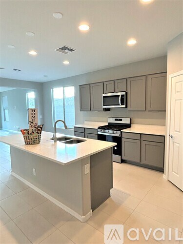 A kitchen with a white countertop and a sign that says "For Sale".