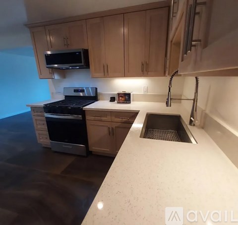 A kitchen with a black stove top oven and a white counter top.