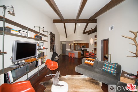 A living room with a grey couch and a television.
