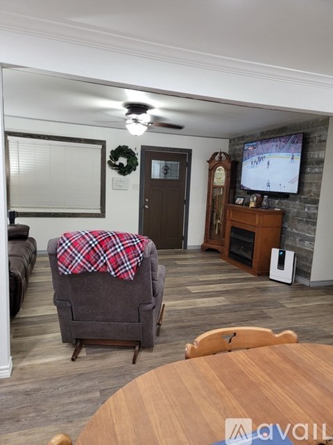 A living room with a grey sofa and a wooden table.