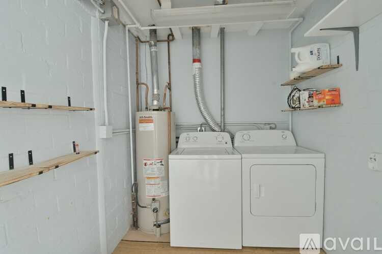 A small laundry room with a washer and dryer.