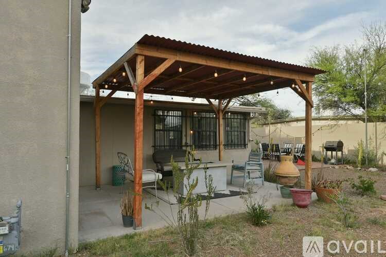 A covered patio area with a table and chairs.