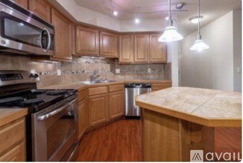 A kitchen with wooden cabinets and a stove top oven.