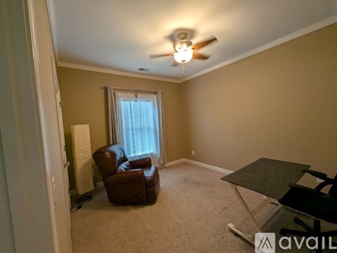 A living room with a brown leather chair and a small table.