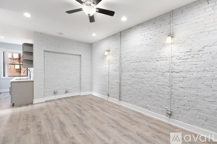 A room with a ceiling fan and lighting fixtures.