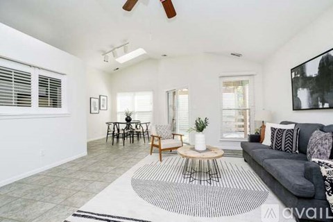 A living room with a grey couch and a coffee table.