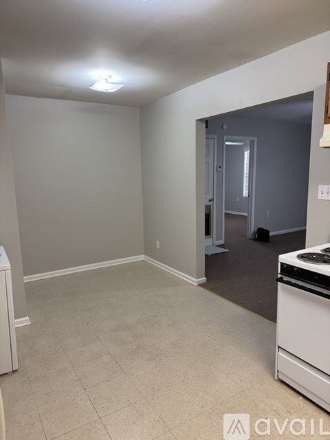 A kitchen area with a dishwasher and a stove top oven.