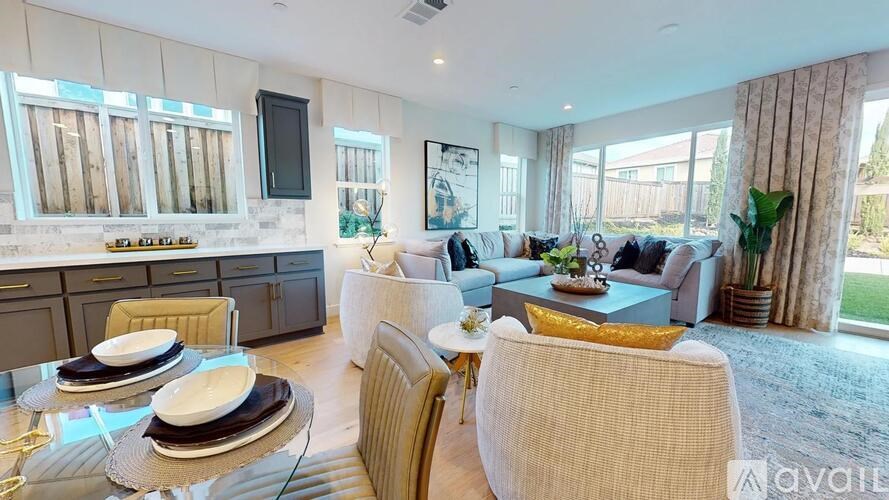 A modern living room with a glass table and a sofa.