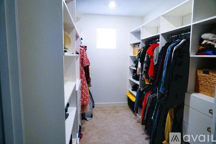 A bathroom with a tub, sink, and mirror.