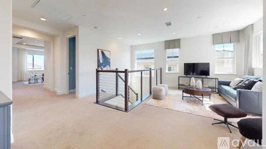 A living room with a couch, a chair, and a television.