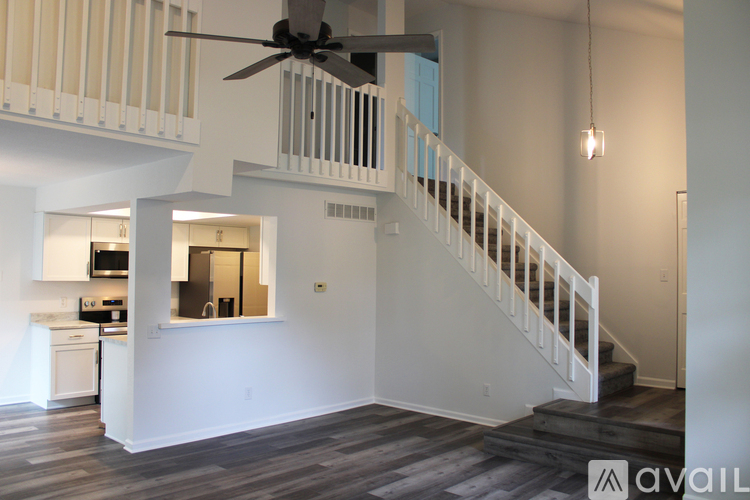 A living room with a staircase leading to the upper floor.