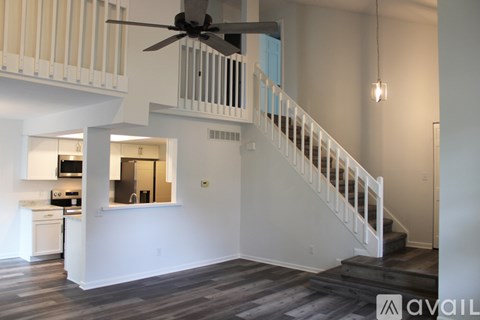 A living room with a staircase leading to the upper floor.