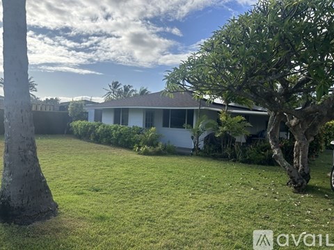 A house with a lawn and trees in front of it.