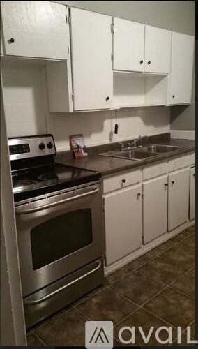 A kitchen with white cabinets and a stainless steel oven.