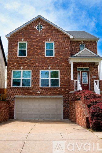 A brick house with a white garage door.