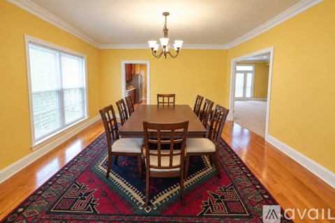 A dining room with a table set for six.