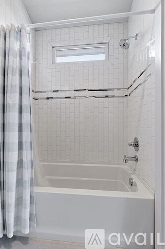 A white bathroom with a tub and shower.